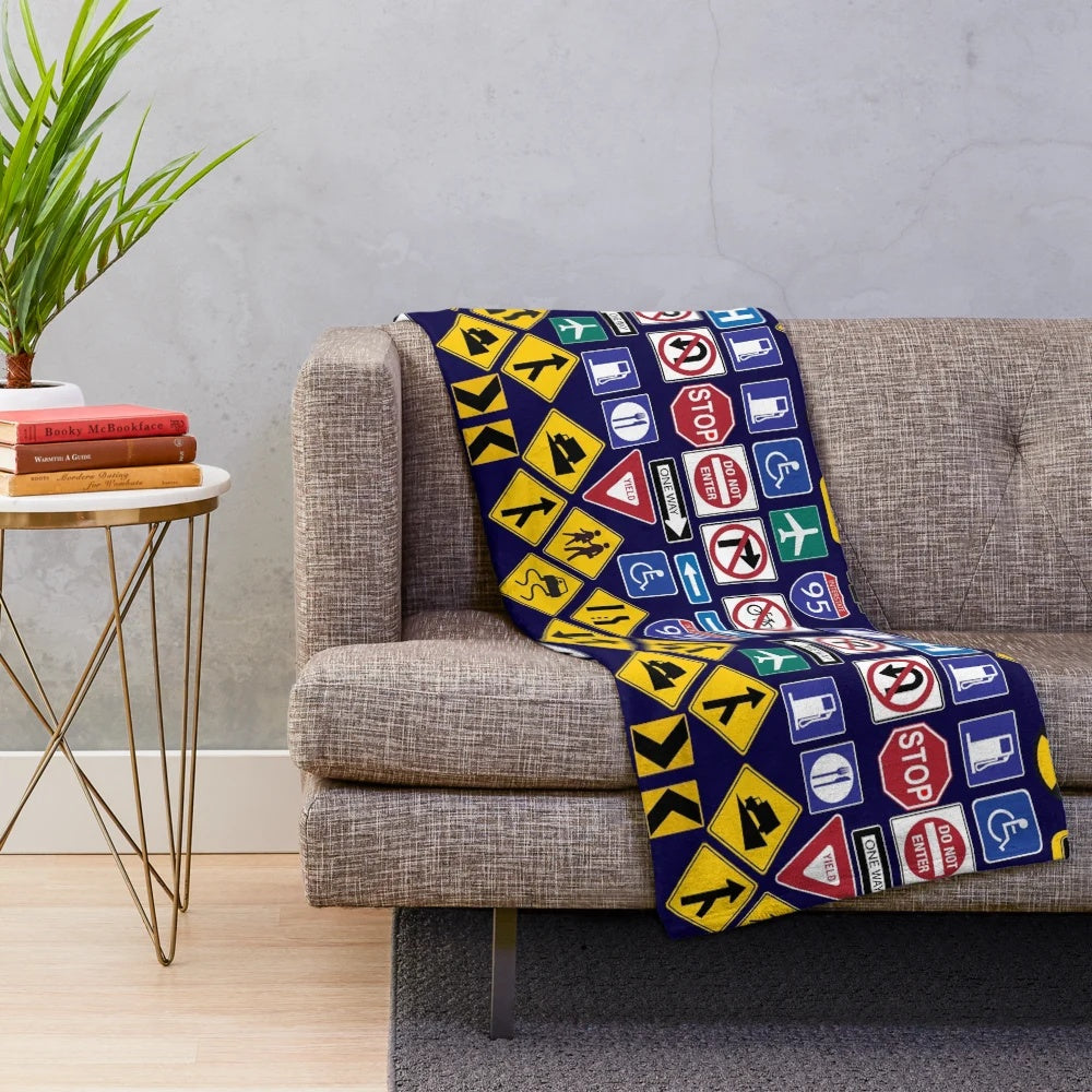 Road signs and traffic regulation symbols printed on a soft, plush blanket
