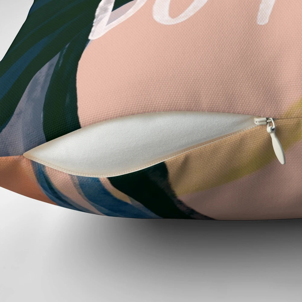 A plush, decorative pillow featuring an abstract art design and an inspiring, motivational quote.