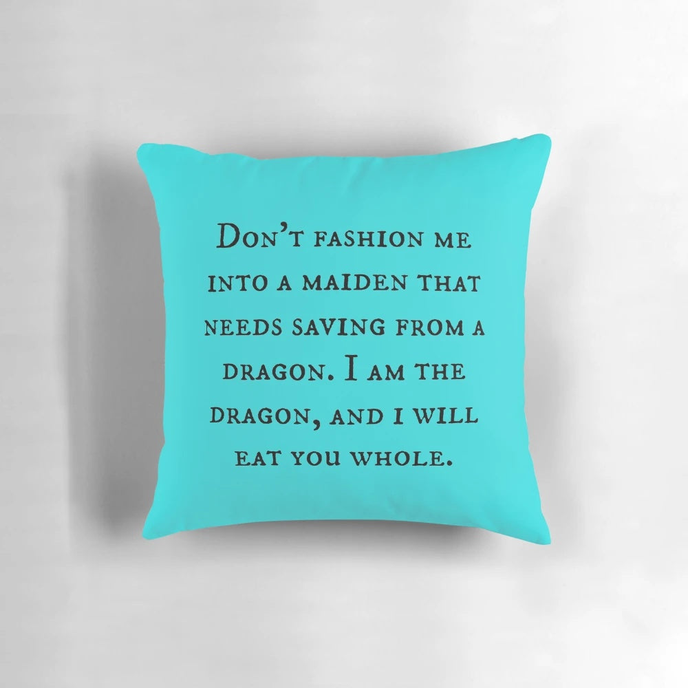A decorative throw pillow featuring a dragon and motivational feminist quote
