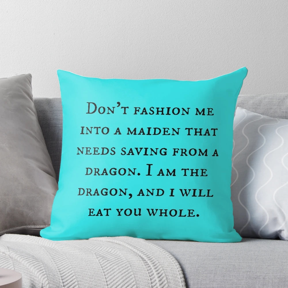 A decorative throw pillow featuring a dragon and motivational feminist quote