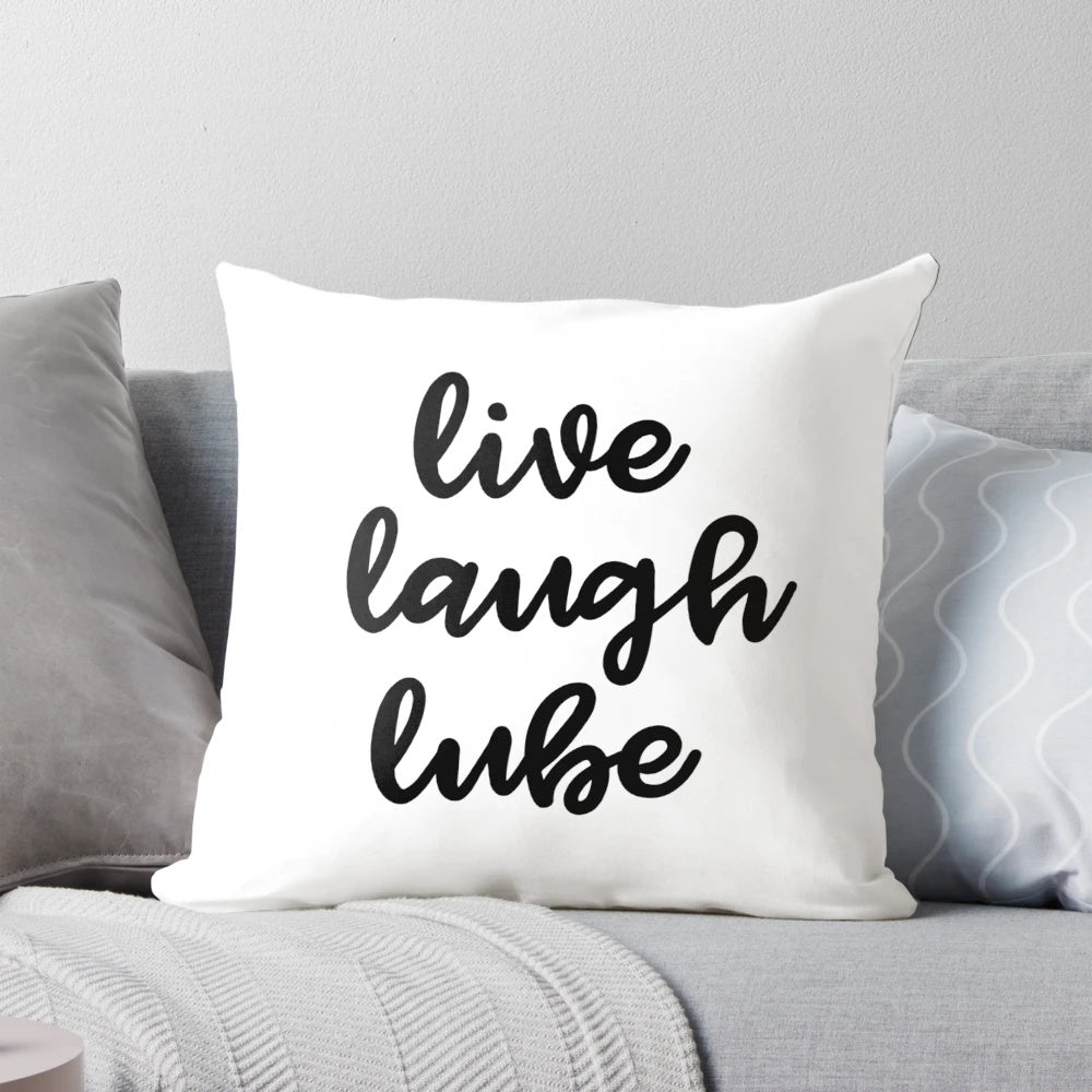 A plush, inspirational pillow with the text 'Live, Laugh, Lube' printed on it.