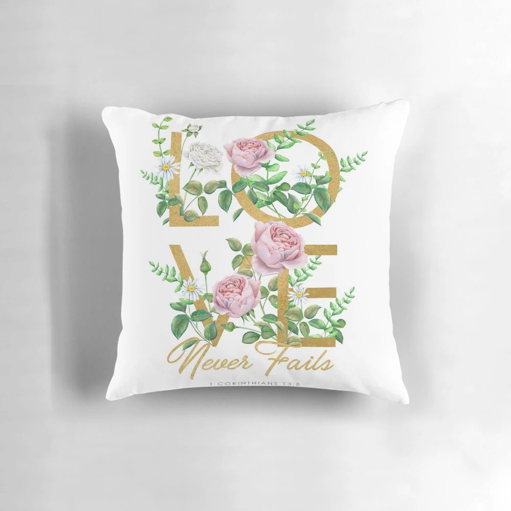 "Love Never Fails" throw pillow with floral and typography design