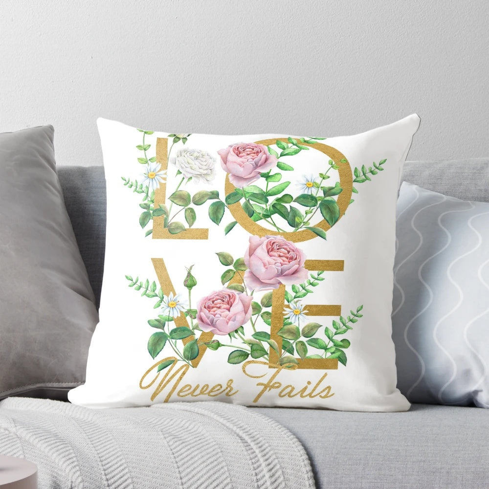 "Love Never Fails" throw pillow with floral and typography design