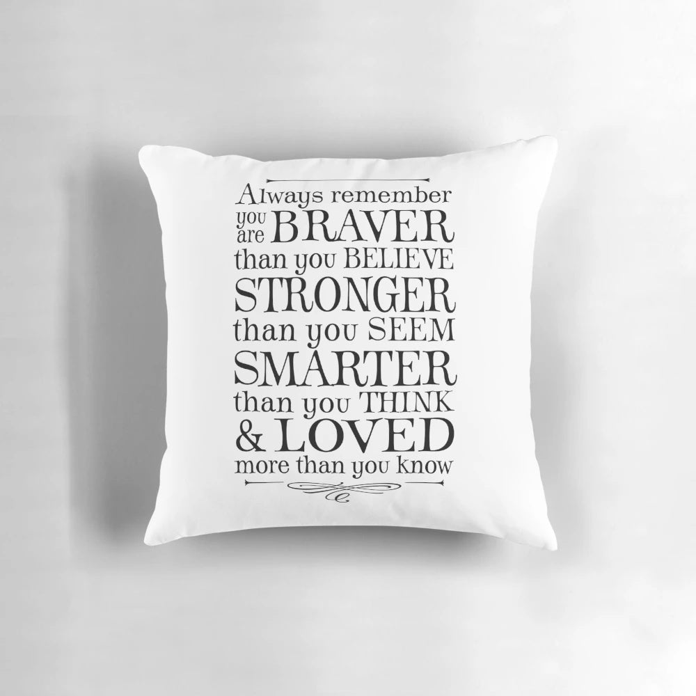 Black and white throw pillow with the text "You are braver than you believe" in a stylized font.