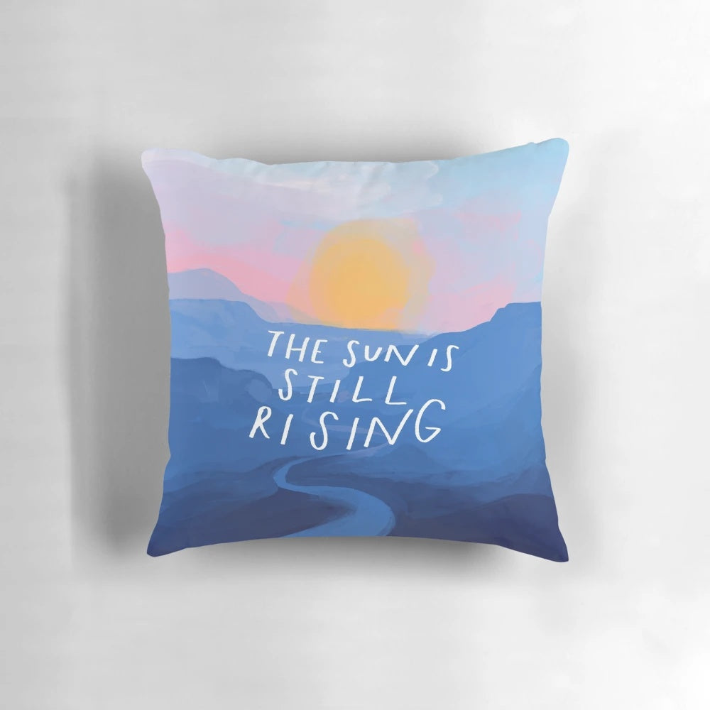 Pillow featuring an inspirational quote and abstract blue mountain sunrise landscape design, painted by Morgan Harper Nichols.