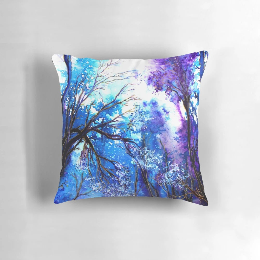 A tranquil watercolor painting of a tree with the words "Ray of Hope" on a decorative pillow.