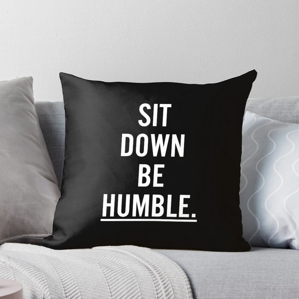 Throw pillow with the text "MUSIC : SIT DOWN BE HUMBLE"
