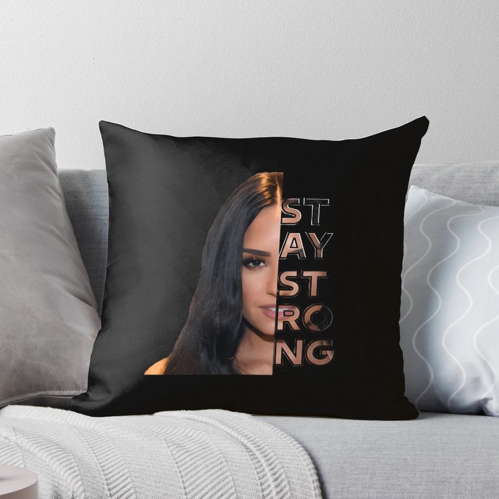 A soft, white pillow with the words "Stay Strong" and Demi Lovato's name printed on it.