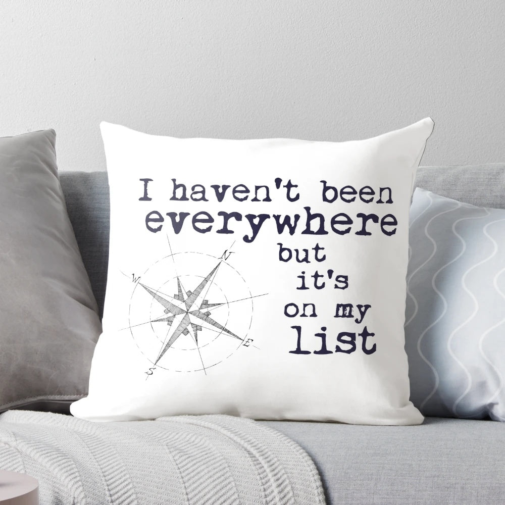 Throw pillow featuring the inspirational travel quote "I Haven't Been Everywhere But It's On My List" by Susan Sontag, with a globe and compass design.