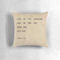 Pillow with inspirational typography quote "Live in the sunshine, swim in the sea, drink the wild air" in minimalist design