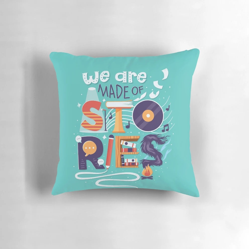 Decorative throw pillow with hand lettered inspirational quote "We Are Made of Stories
