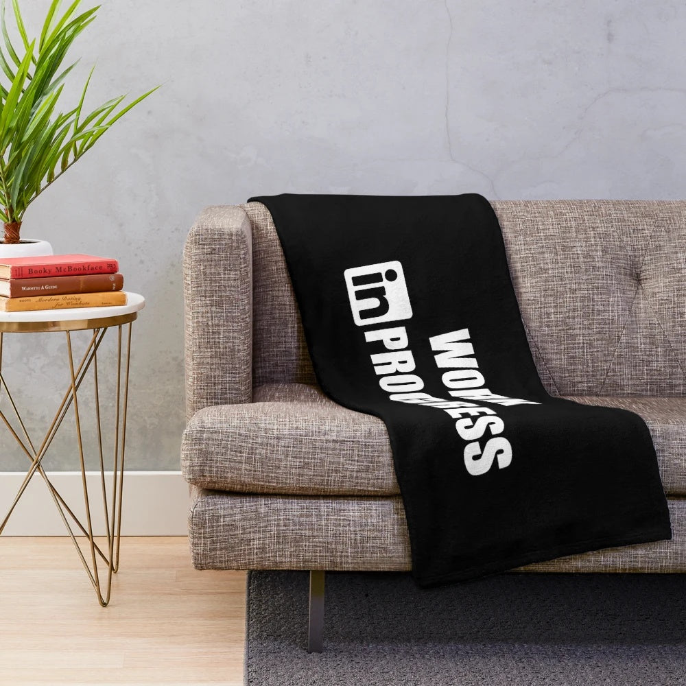 Inspirational plush blanket with "Work in Progress" design