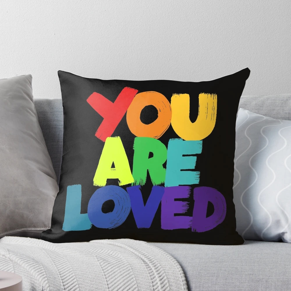 Colorful 'You Are Loved' typography pillow with rainbow lettering