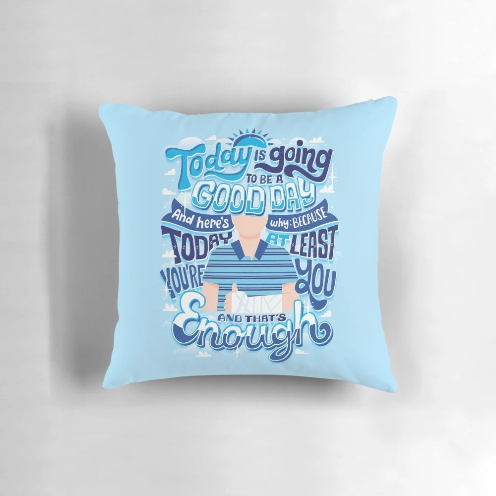 An inspirational throw pillow with the text "You're you and that's enough" in a hand-lettered style.
