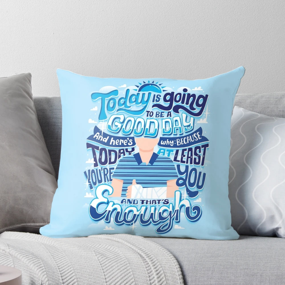 An inspirational throw pillow with the text "You're you and that's enough" in a hand-lettered style.