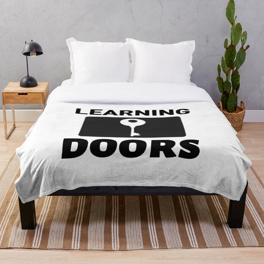 Cozy plush blanket with inspirational "Learning Opens Doors - Teachers Make All Jobs Possible" text