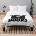 Cozy plush blanket with inspirational "Learning Opens Doors - Teachers Make All Jobs Possible" text