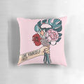 A white pillow with a pink floral pattern and the text "Love yourself first" printed on it.