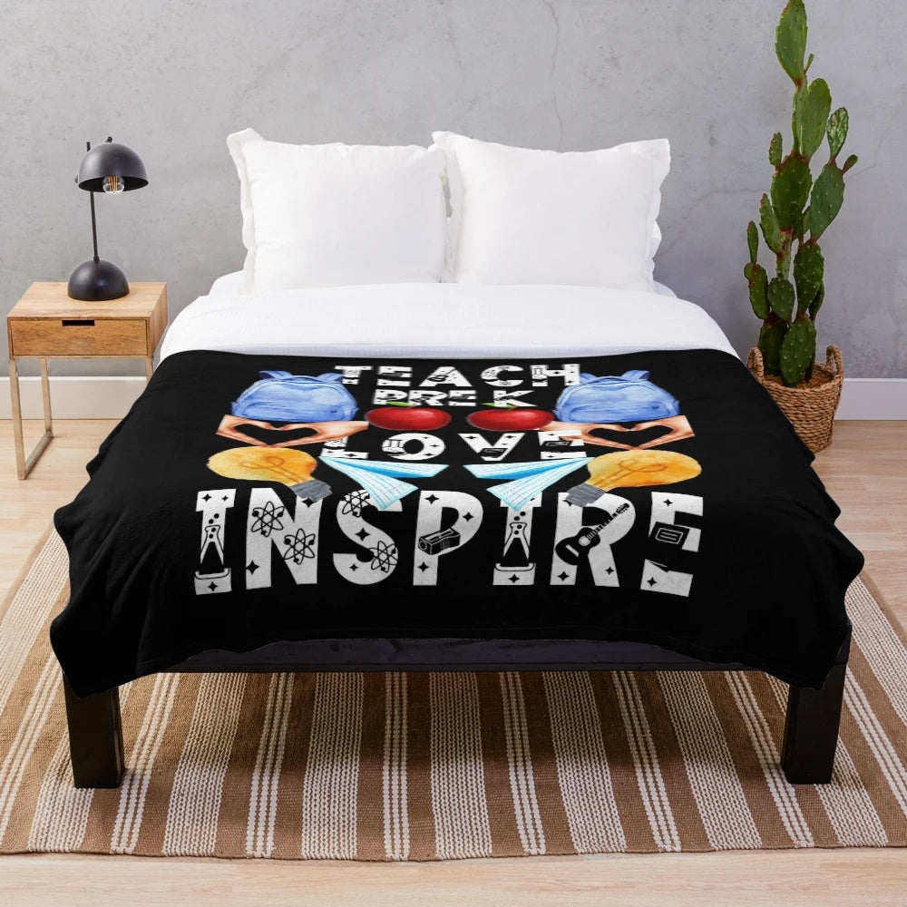 Plush blanket with "teach love inspire" text, ideal for pre-K teachers and education professionals.