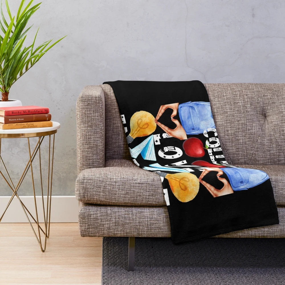 Plush blanket with "Teach, College, Love, Inspire" text design