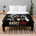 Hadestown-inspired plush blanket featuring key characters and symbols from the acclaimed musical