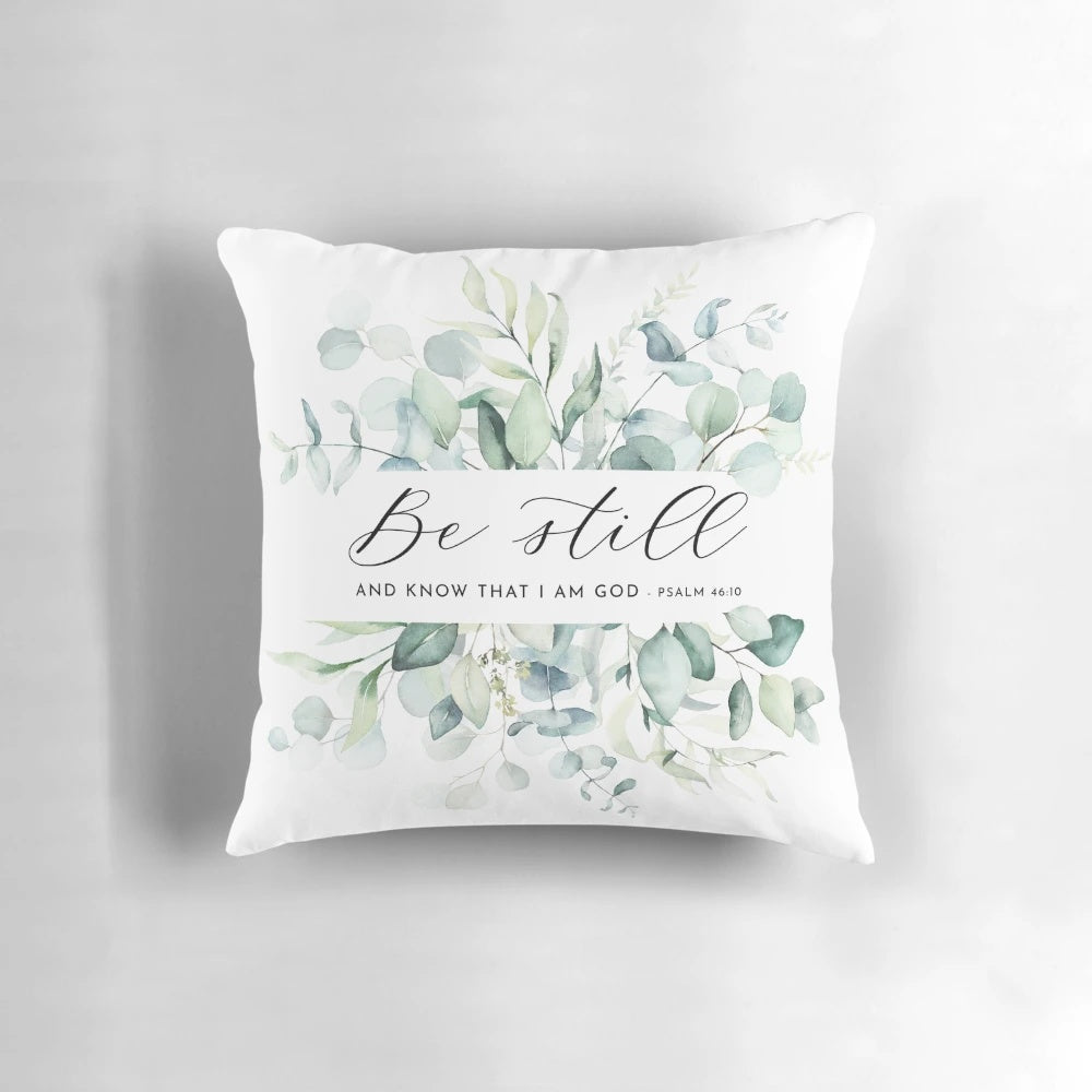 "Be Still" Christian wall decor pillow with Psalm 46:10 Bible verse and foliage design