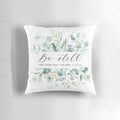 "Be Still" Christian wall decor pillow with Psalm 46:10 Bible verse and foliage design