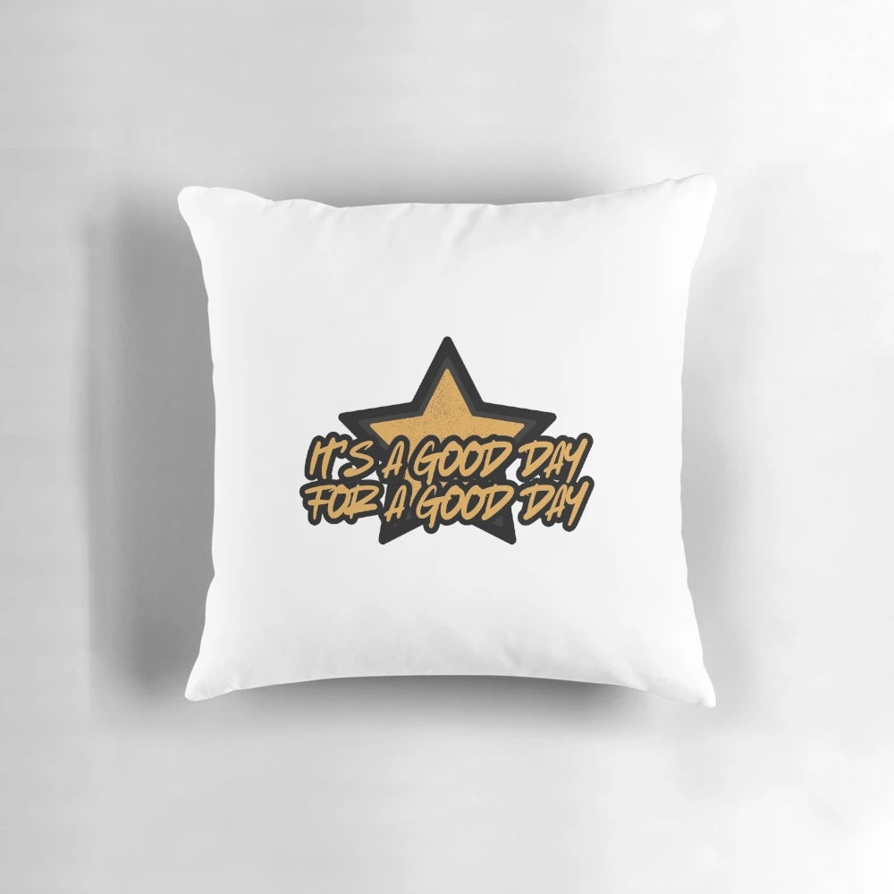 A black and gold throw pillow with the words "Good Day" printed in a motivational, uplifting design.