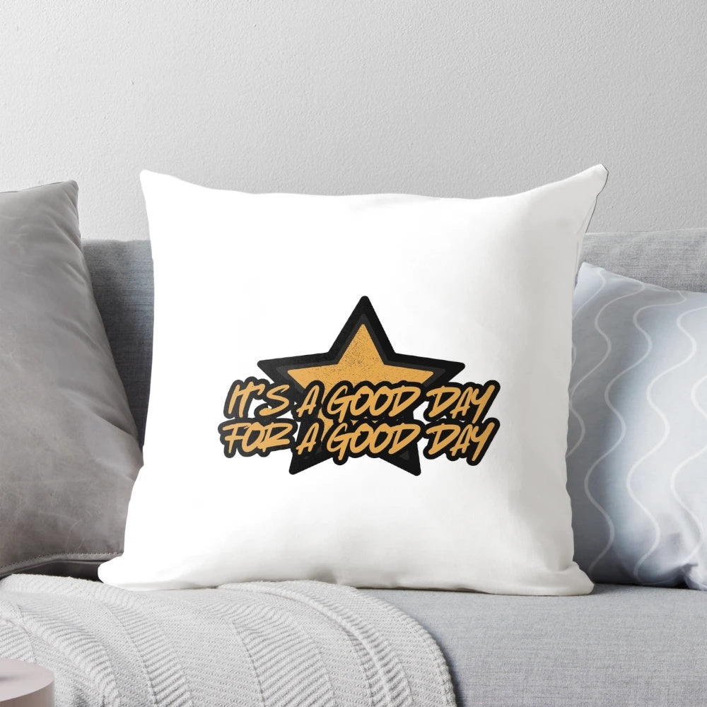 A black and gold throw pillow with the words "Good Day" printed in a motivational, uplifting design.