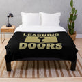 Plush blanket with inspirational "Learning Opens Doors" design, featuring teachers