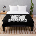 Cozy plush blanket with text "Learning Opens Doors - Teachers Make All Jobs Possible