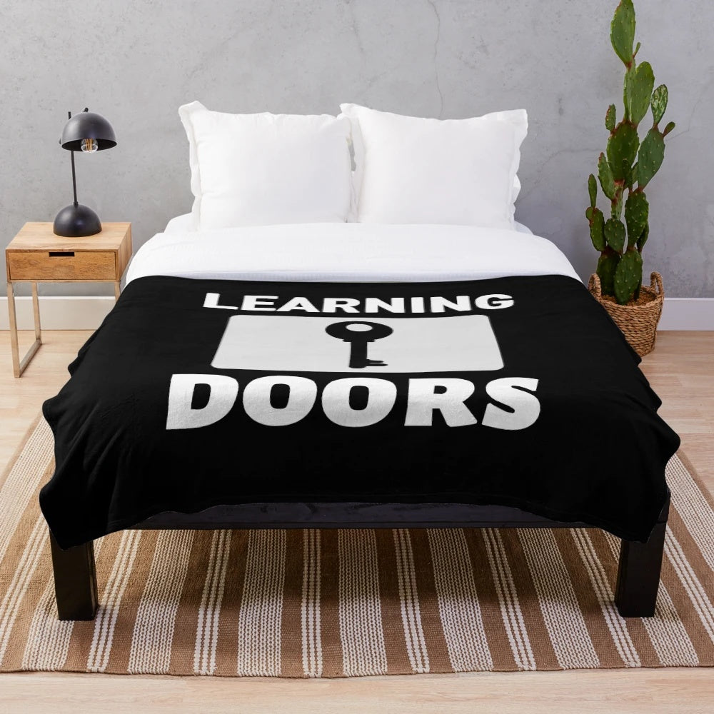 Cozy plush blanket with text "Learning Opens Doors - Teachers Make All Jobs Possible