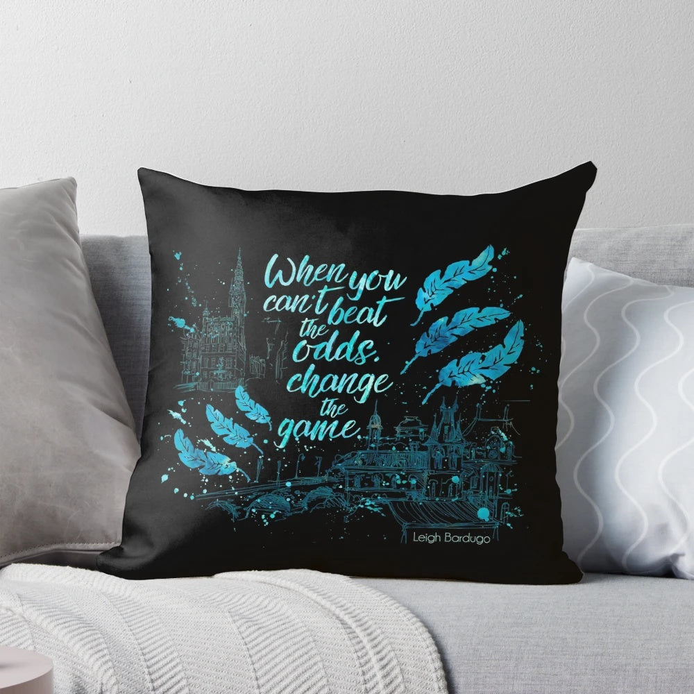 A decorative pillow featuring a quote from the book "Six of Crows" by Leigh Bardugo, with watercolor typography art.
