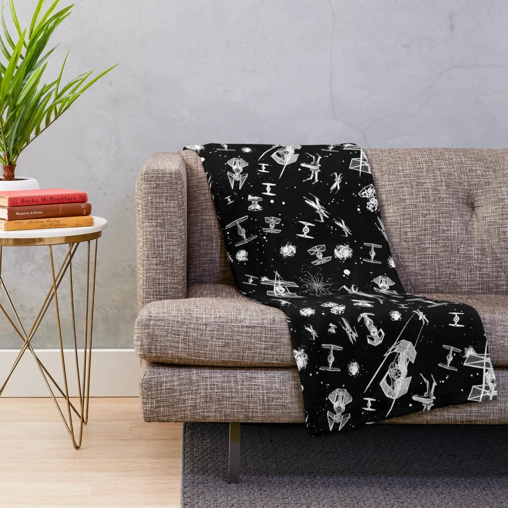 Plush blanket featuring a space battle scene with spaceships and stars