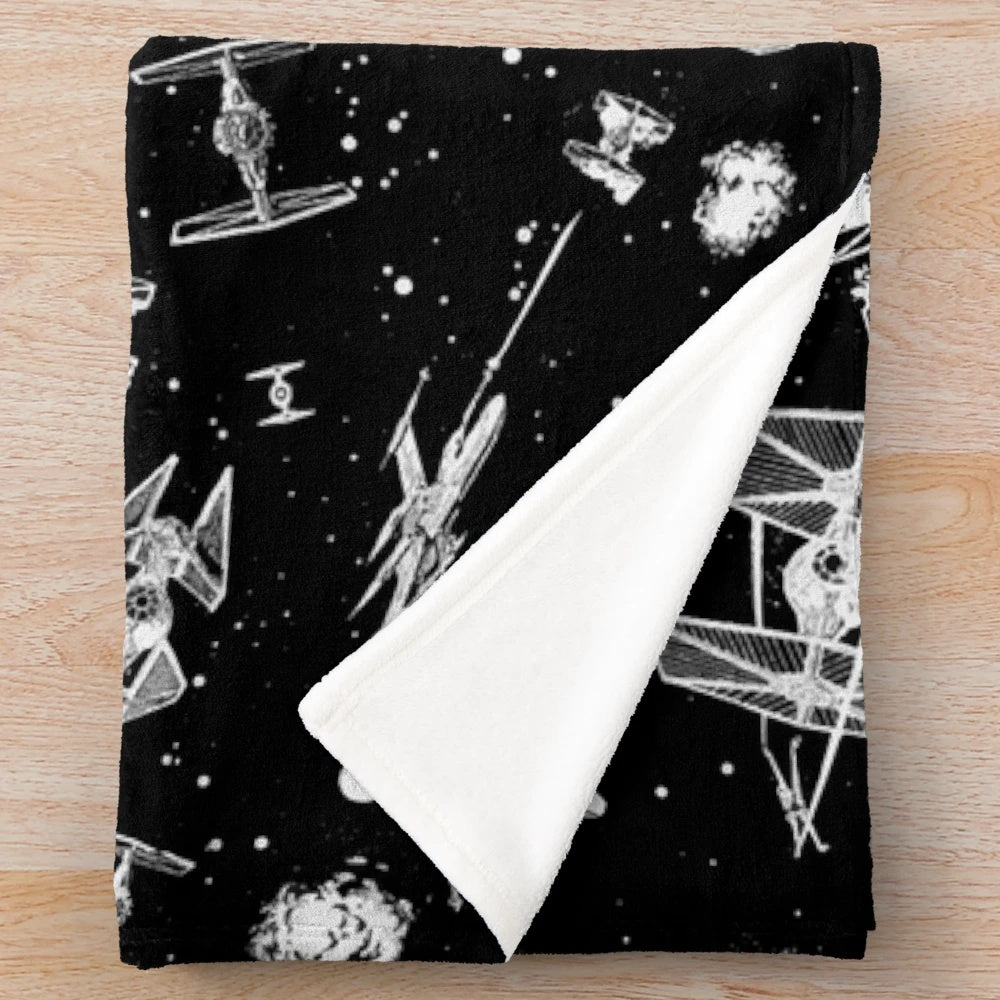 Plush blanket featuring a space battle scene with spaceships and stars