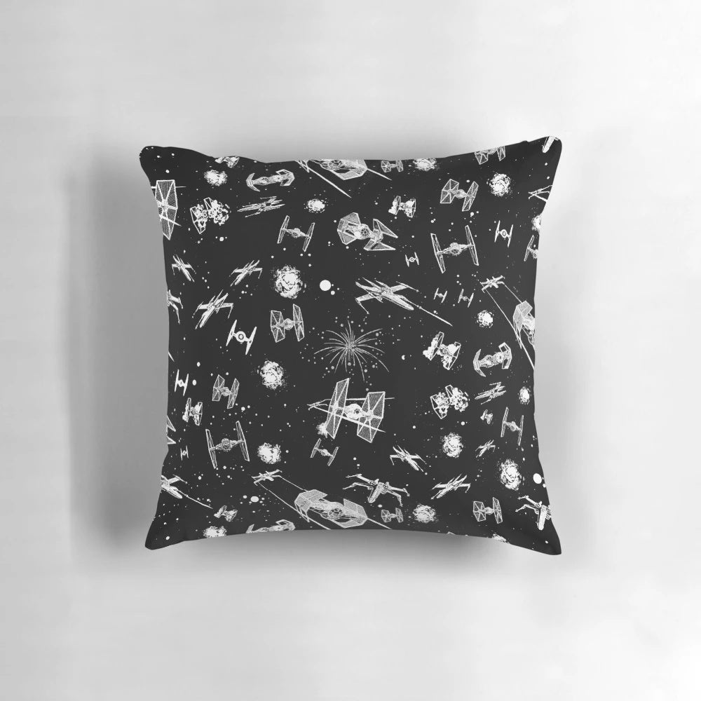 Colorful throw pillow featuring a space battle scene with spaceships and stars