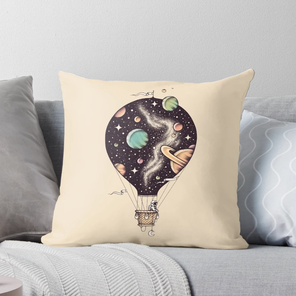 Interstellar Journey Pillow featuring a design of planets, stars, and a hot air balloon in space