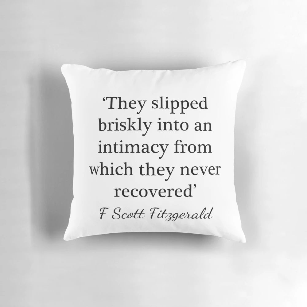 F. Scott Fitzgerald quote "They slipped briskly into an intimacy" printed on a decorative pillow