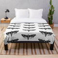 Detailed death's-head hawkmoth design on a plush, cozy blanket