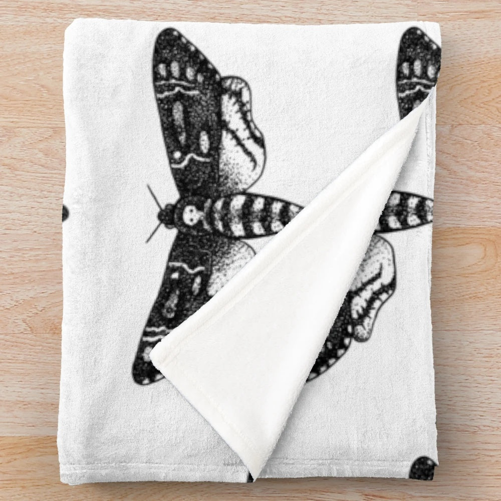 Detailed death's-head hawkmoth design on a plush, cozy blanket