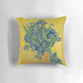 A decorative throw pillow featuring Vincent Van Gogh's iconic "Vase with Irises Against a Yellow Background" painting.