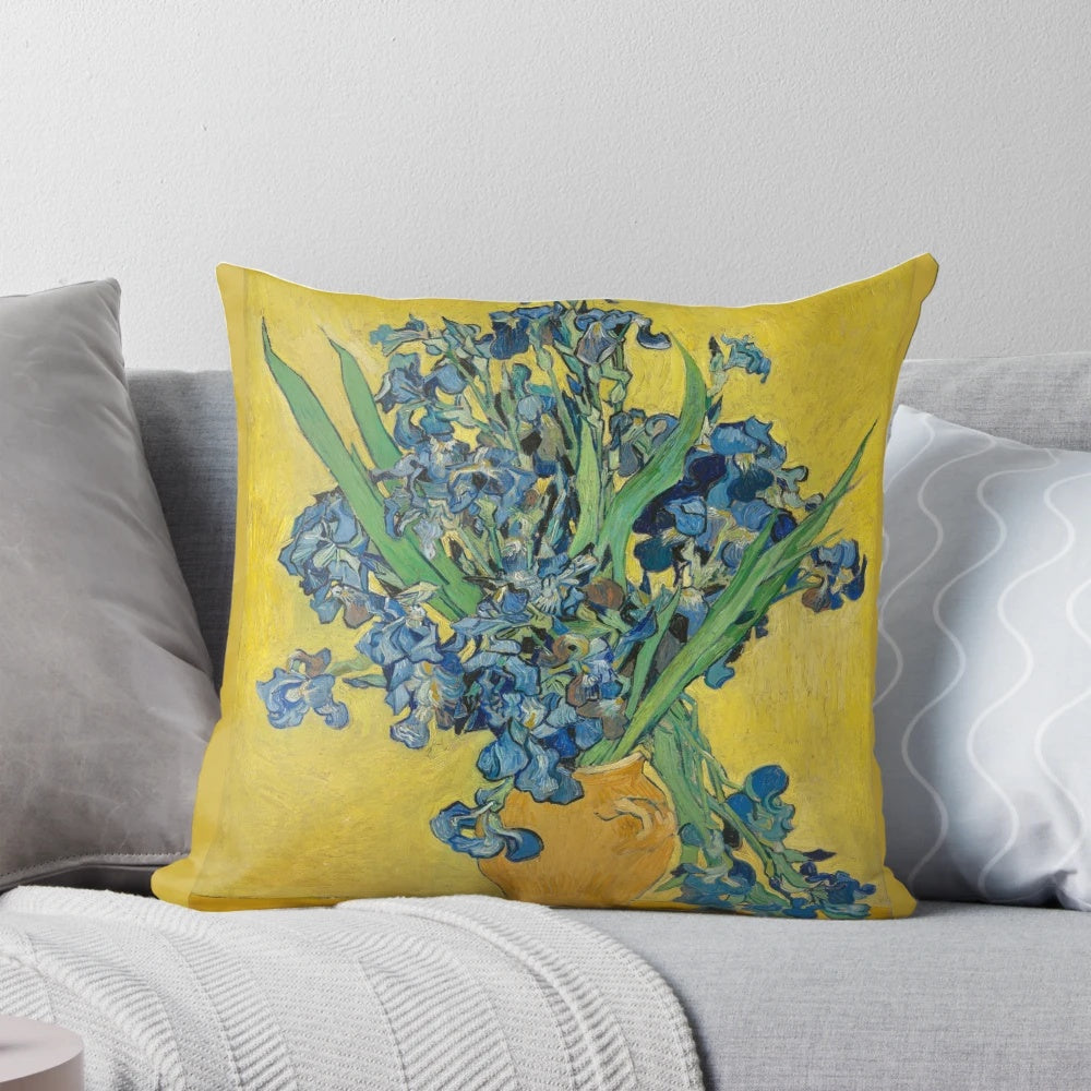 A decorative throw pillow featuring Vincent Van Gogh's iconic "Vase with Irises Against a Yellow Background" painting.