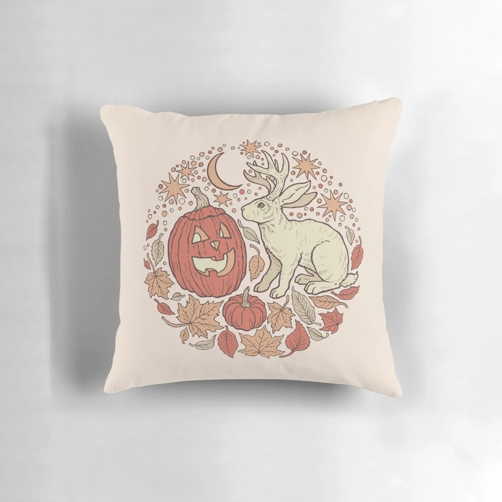 Pillow featuring a whimsical jackalope and jack-o-lantern in an autumnal scene, perfect for Halloween and fall decorating.
