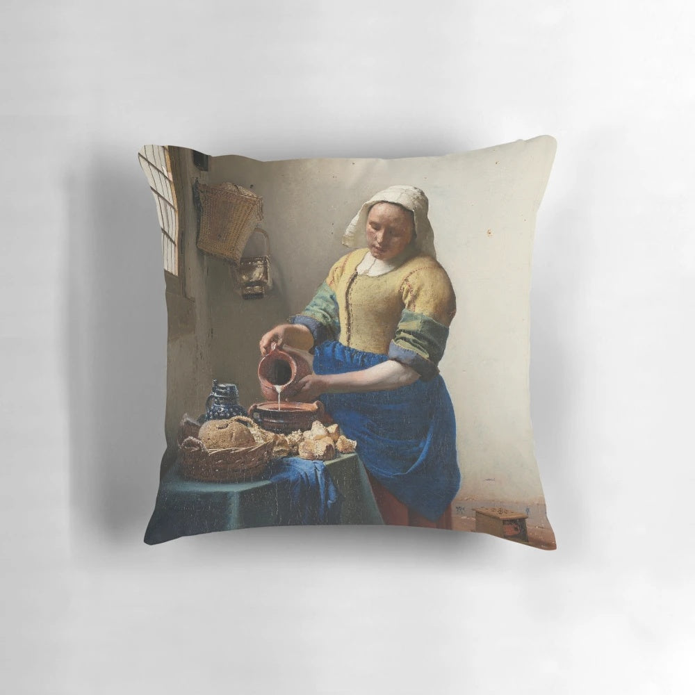 A decorative throw pillow featuring Johannes Vermeer's iconic painting "The Milkmaid" from the Dutch Golden Age.
