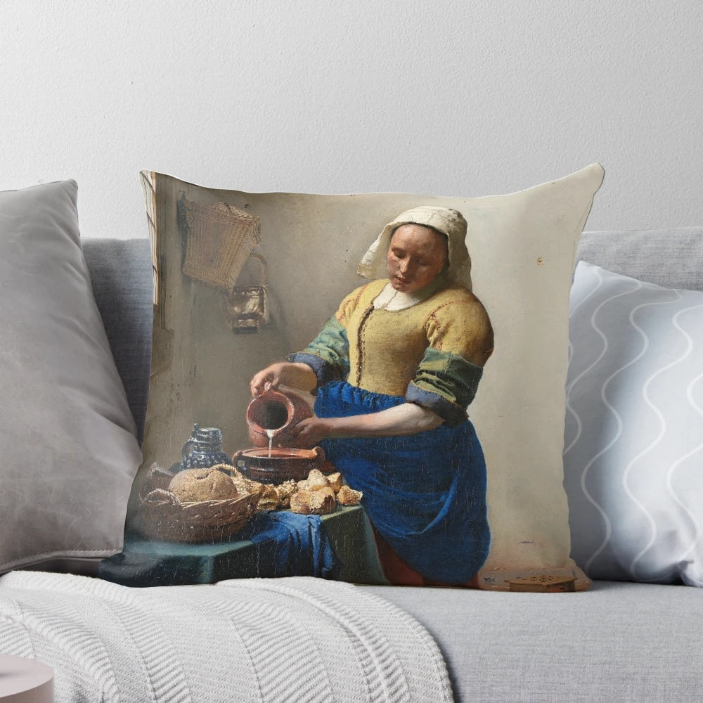 A decorative throw pillow featuring Johannes Vermeer's iconic painting "The Milkmaid" from the Dutch Golden Age.