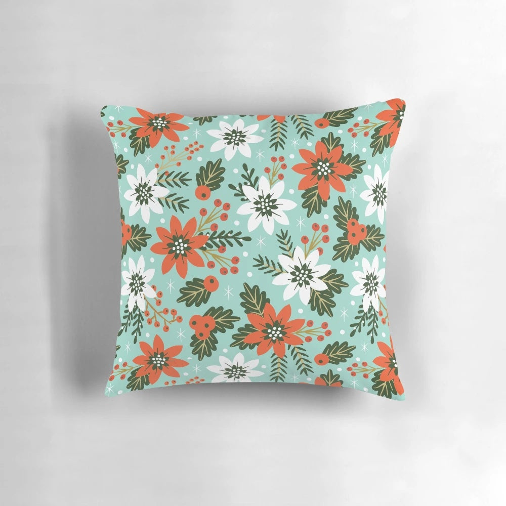 Festive Christmas floral pillow with poinsettias, holly, and snowy accents