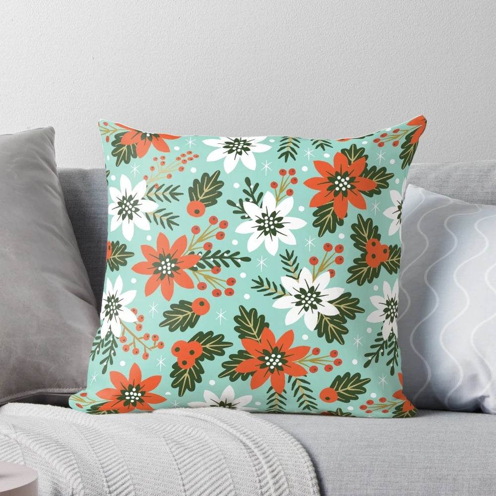 Festive Christmas floral pillow with poinsettias, holly, and snowy accents