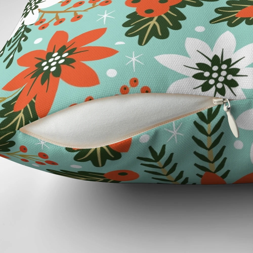 Festive Christmas floral pillow with poinsettias, holly, and snowy accents