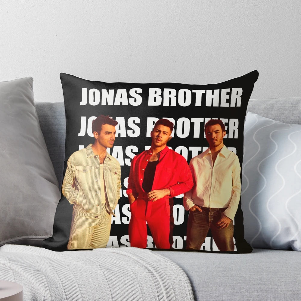 A plush pillow featuring the Jonas Brothers band members - Nick Jonas, Joe Jonas, and Kevin Jonas