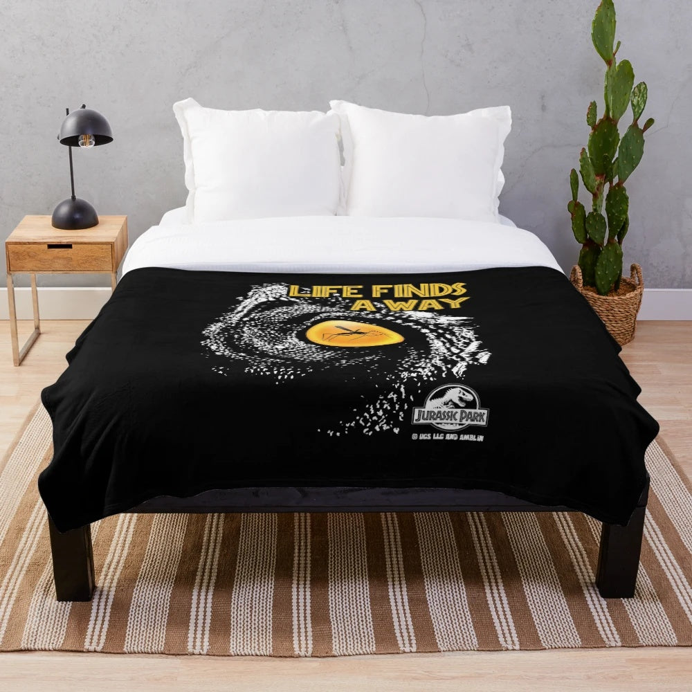 Jurassic Park inspired plush blanket featuring the iconic "Life Finds A Way" quote